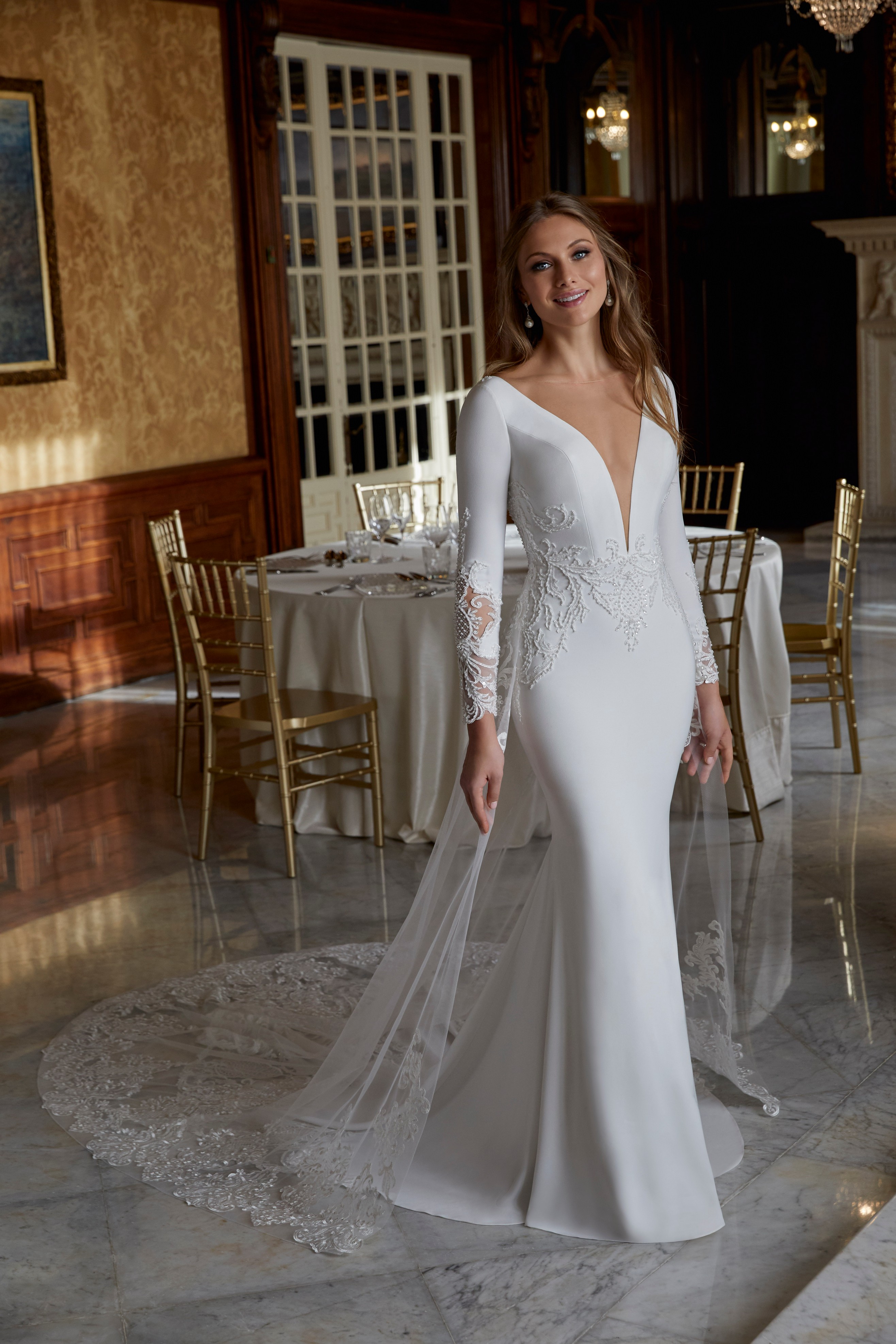 Model wearing one of our Ronald Joyce hot wedding dress trends, Doris (style 69573) and matching sheer tulle train. 