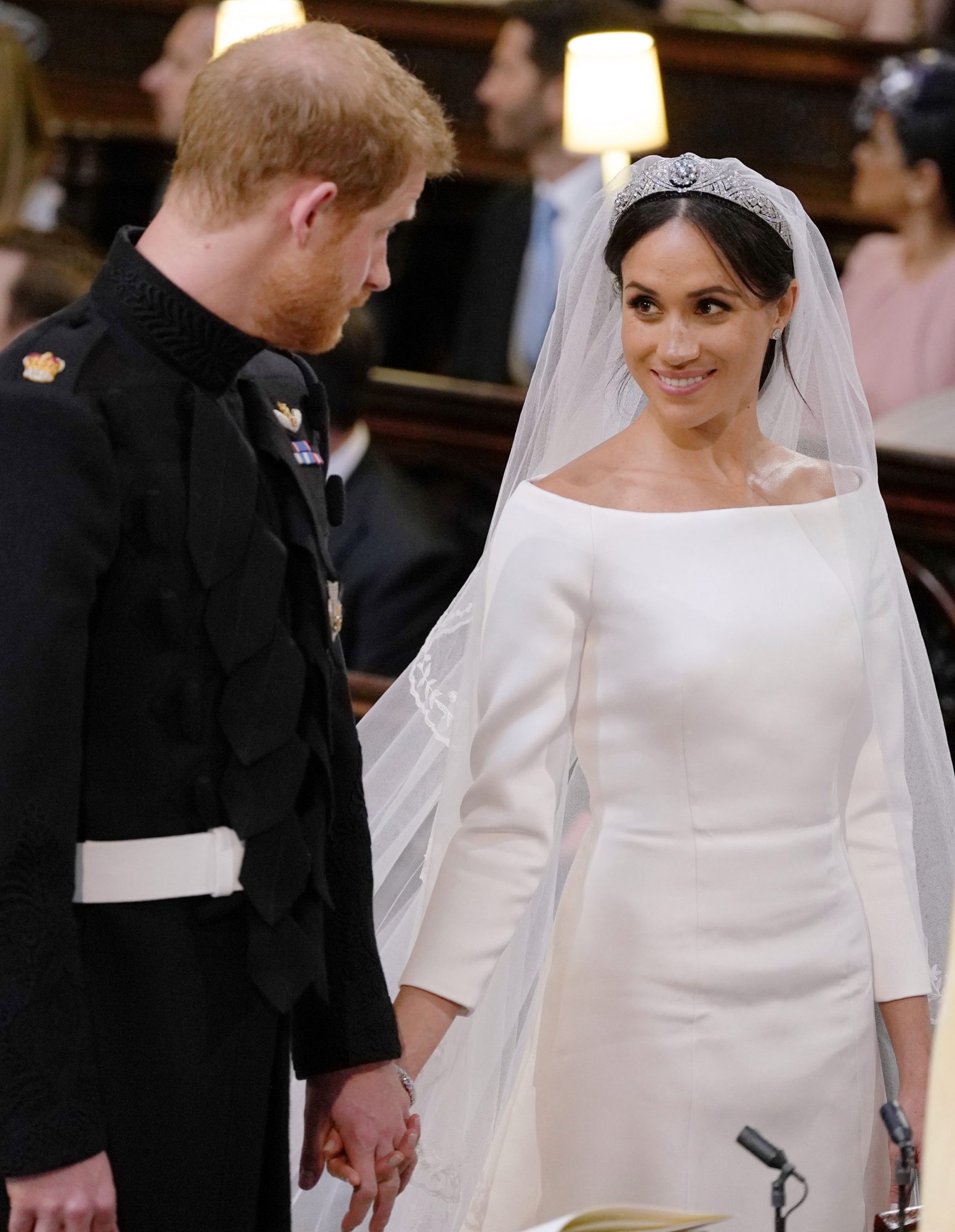 Megan Markle at wedding to Prince harry wearing off the shoulder fit and flare wedding gown