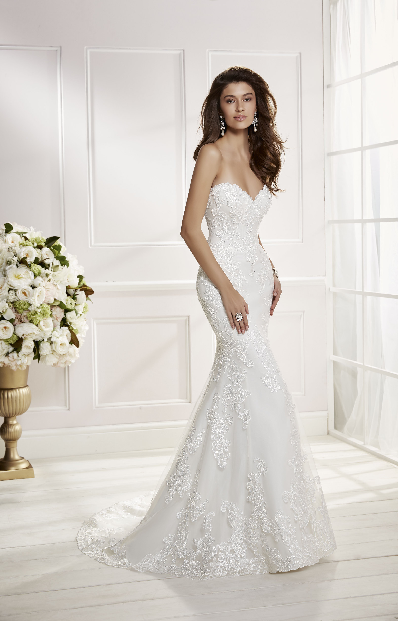 Model wearing Ronald Joyce wedding dress style Carina, 69455, a strapless on-trend lace fit and flare wedding dress with a sweetheart neckline 