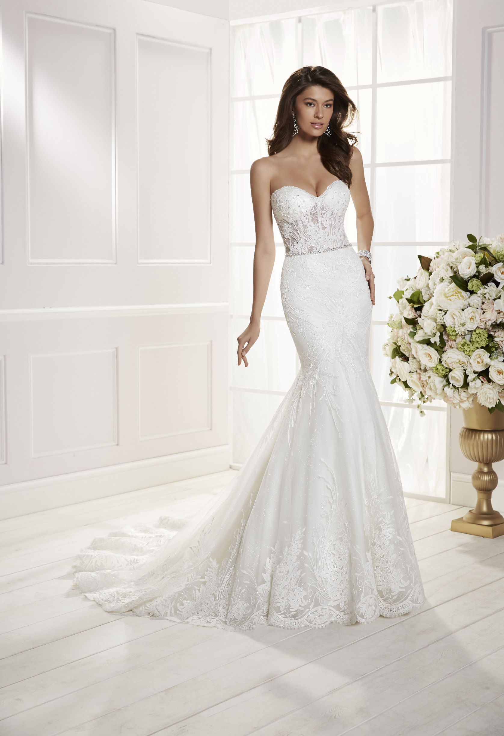 Model wearing Ronald Joyce wedding dress style Chiara, 69461, an on-trend strapless lace fishtail wedding dress with lingerie-inspired bodice