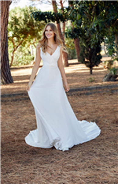 Bride stood in a sunny wooded area wearing Ronald Joyce 69515, a strappy plain chiffon wedding dress with a v-neckline, ruched cross over body and A-line skirt