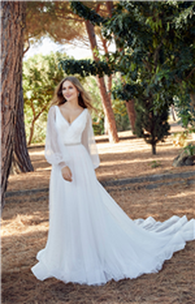 Bride stood in a sunny wood in Ronald Joyce 69515, a strappy plain A-line wedding dress with a v-neckline and long sheer detachable pearl-beaded sleeves and a sparkle belt for two looks.