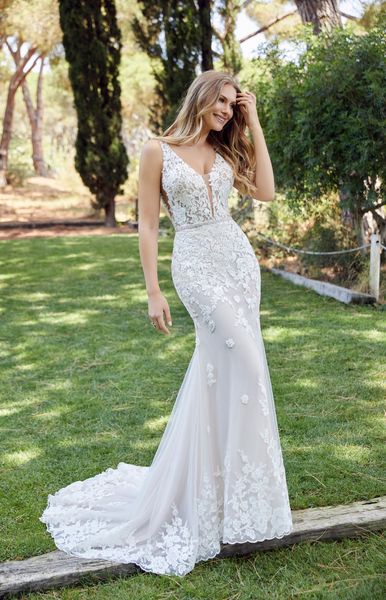 Bride stood near woodland wearing Ronald Joyce 69527, a chiffon, lace and tulle fit and flare wedding dress with a plunging illusion neckline and sparkle belt