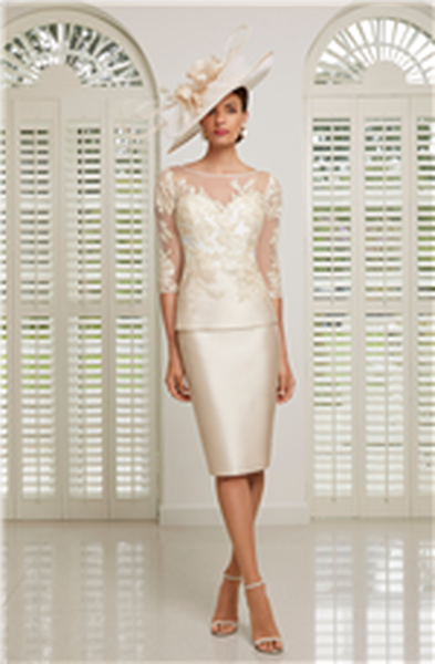 Model stood in Veni Infantino 991508, a fashionable champagne colour mother of the bride dress for 2020 with a fitted Mikado knee-length skirt and Mikado and lace illusion sweetheart top with ¾ sleeves.