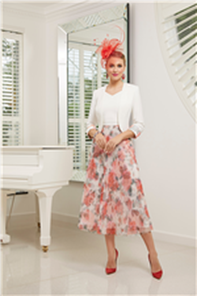 Model wears a red fascinator and Veni Infantino, 991518, a fashionable calf-length mother of the bride dress with a pleated rose print skirt and plain ivory body. Model also wears a cropped ivory jacket with rose print cuff. 