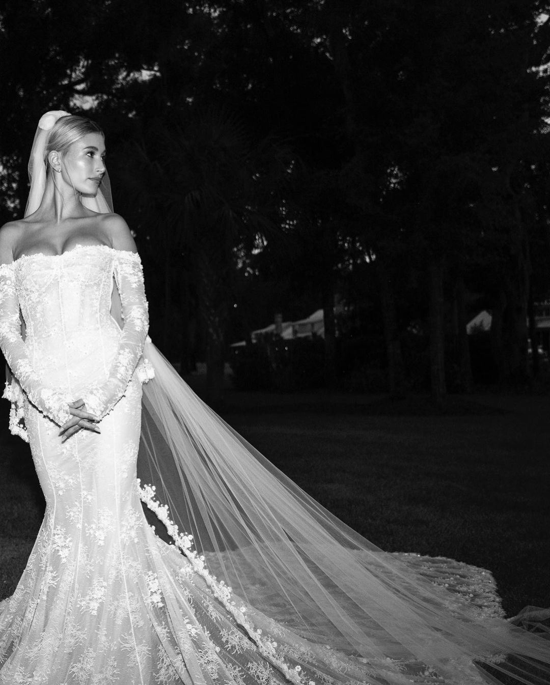Hailey Bieber on wedding day wearing lace fit and flare off the shoulder wedding dress 