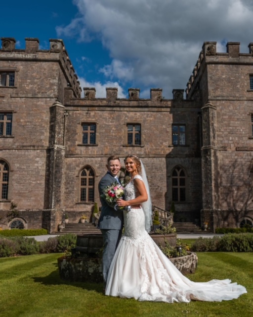 Couple outside castle on their wedding day