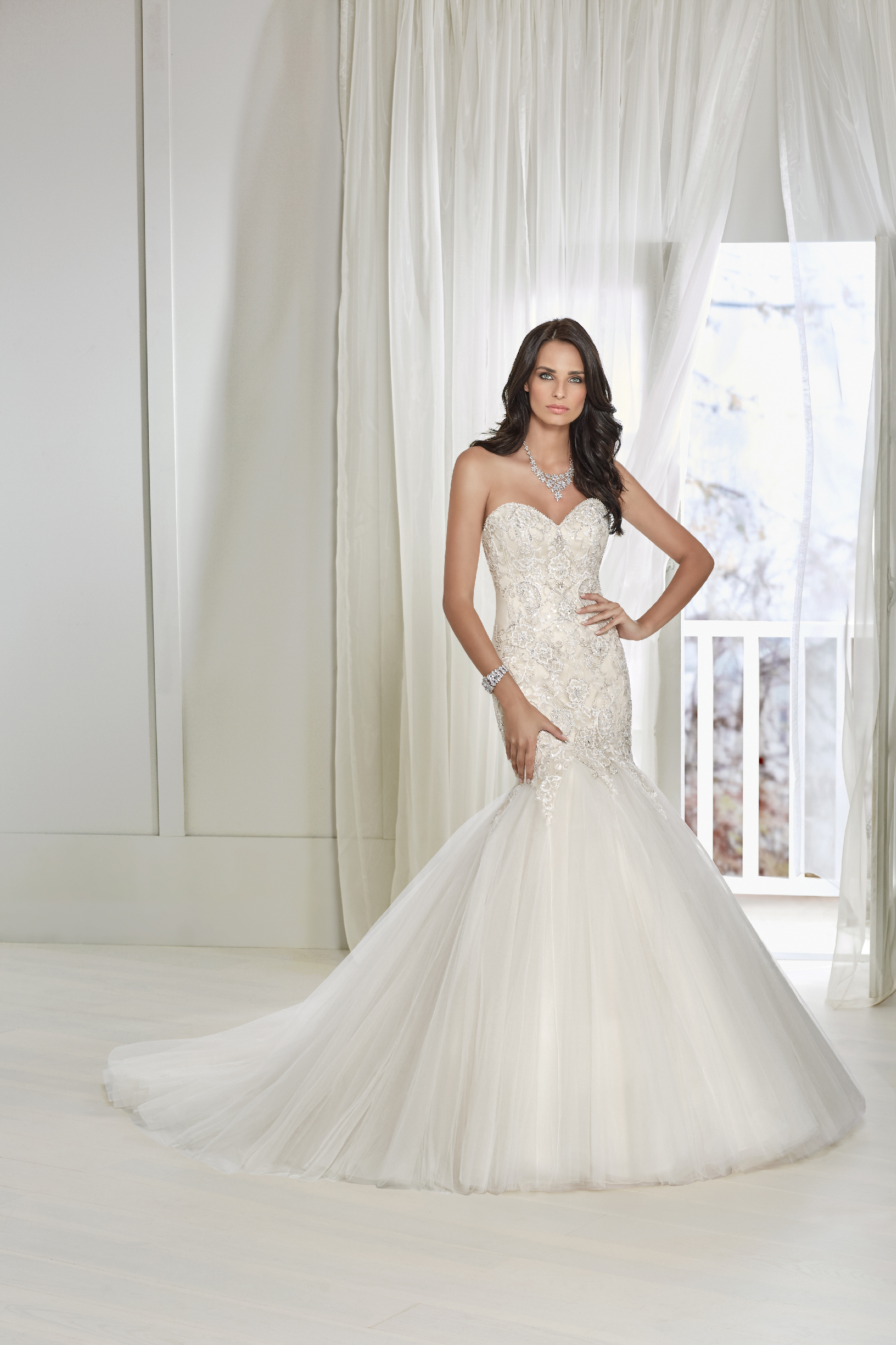 Model in Ronald Joyce wedding dress 18211 - a strapless fishtail gown with a beaded lace applique bodice and corset back that's perfect if you need a wedding dress quickly