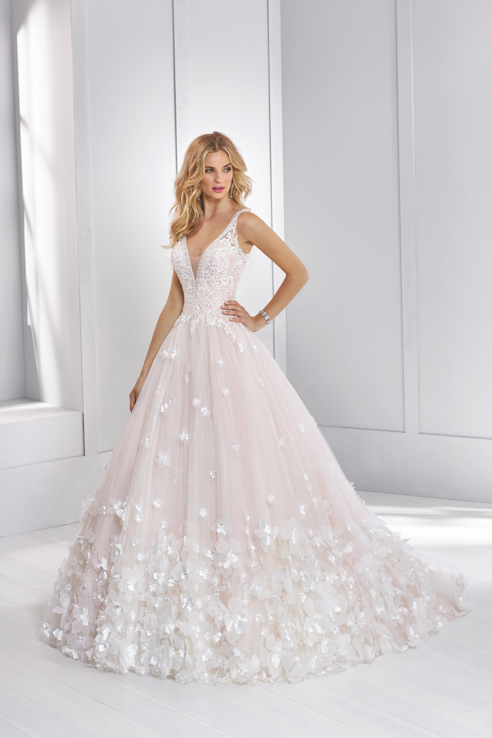 Model wearing Ronald Joyce wedding dress style 69326 - a beautiful ballgown with 3D flowers that's perfect for brides who need a wedding dress quickly.