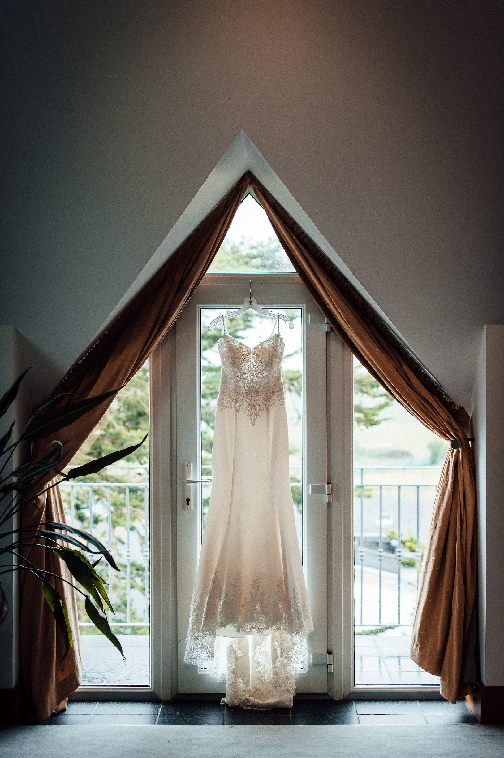 Wedding dress hung up in a door window