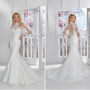 Blonde model stood in a white room in Ronald Joyce 69325, a beaded lace fishtail wedding dress fit for a princess thanks to an illusion back, neckline and matching long sleeves