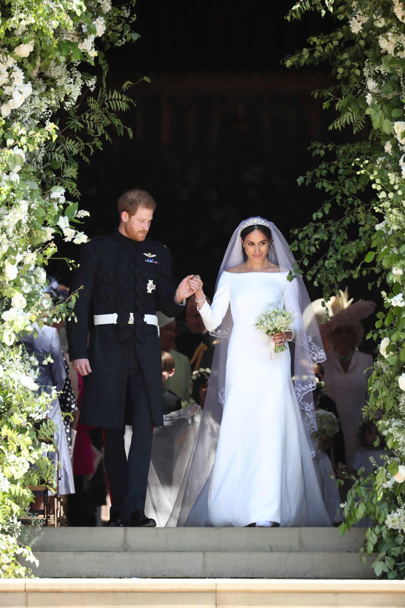 Prince Harry and Megan leave wedding ceremony, megan wears off the shoulder fit and flare wedding dress with matching cathedral veil and diamond tiara